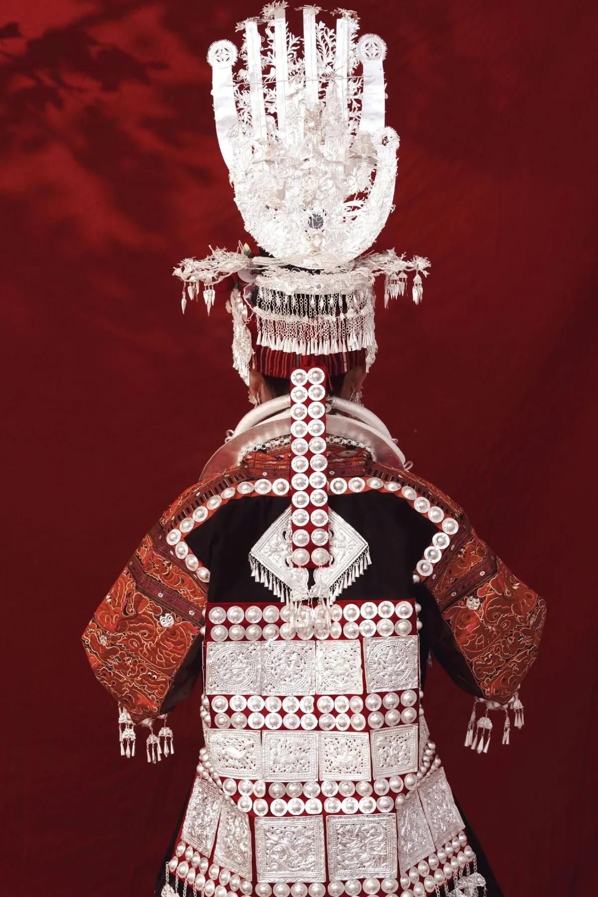 Shidong Miao traditional dress showing studio back.